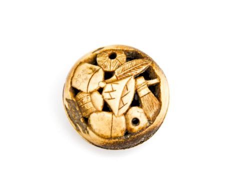 An Oriental bone disc netsuke, carved with domestic objects, diameter 4.5cm 