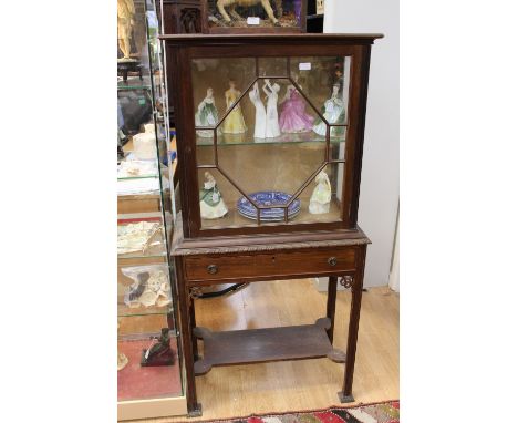 A George III style mahogany display cabinet, in the Chippendale manner, the single glazed door opening to reveal a fitted she