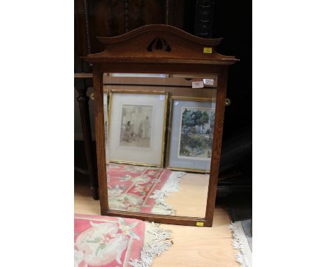 An Arts and Crafts oak mirror 