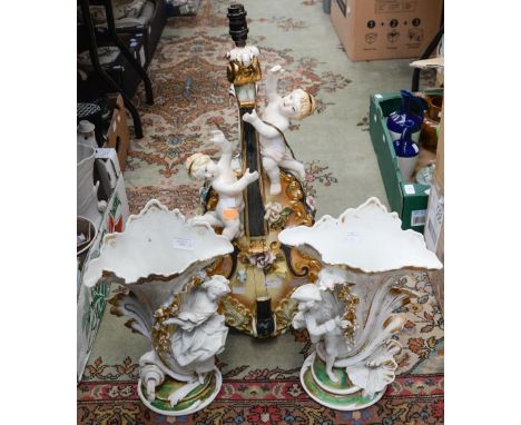 A large Capo di Monte table lamp with shade, in the form of a Violin with cherubs playing it; together with a pair of vases m