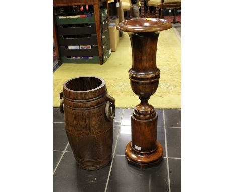 A 20th Century oak stick stand, in the form of a barrel together with a planter in the form of a pedestal urn, (2)