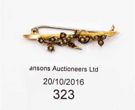 An Edwardian 9ct and seed pearl bar brooch, if the form of a swallow and flowers, approx 41mm, gross weight approx 1.9 grams 