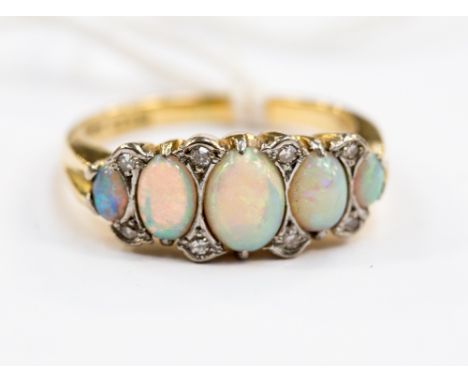 An opal and diamond 9ct yellow gold ring, five graduated opals with diamond points set in white metal, gross weight approx 8.