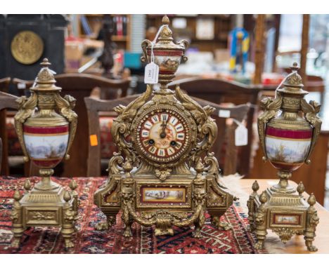 A French gilt metal garniture clock set, comprising an eight day mantle clock and a pair of urns, (3)