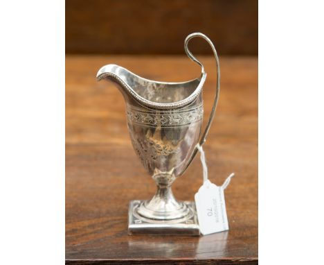 A George III silver helmet shaped cream jug on a square weighted base, hallmark London 1791, makers mark indistinct but proba