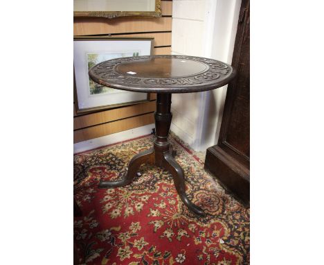 A Georgian circular tripod table with geometric carved top 