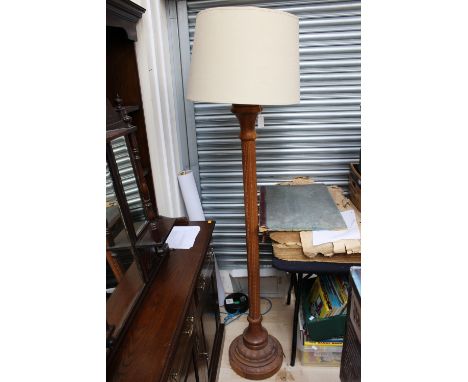 A contemporary oak standard lamp, carved frame