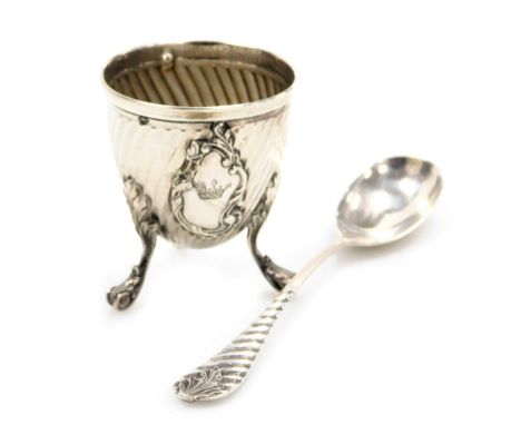 A late 19thC Chinese export egg cup, of diagonally fluted form, with rococo reserve engraved with a coronet, raised on three 