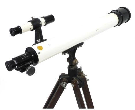 A Unicon night telescope, with a F=600mm, D=50mm lens, on a wooden tripod.