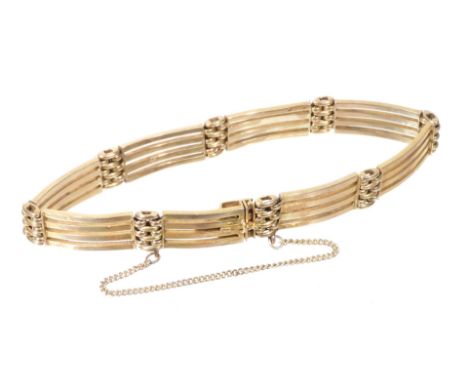 A four bar gate bracelet, yellow metal, on a snap clasp, with safety chain as fitted, stamped 9ct, 12.2g.