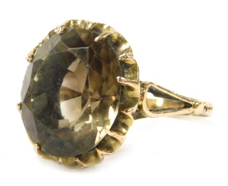 A 9ct gold and smoky quartz ring, the oval cut stone in a basket setting, approx 6cts, size M, 4.2g.