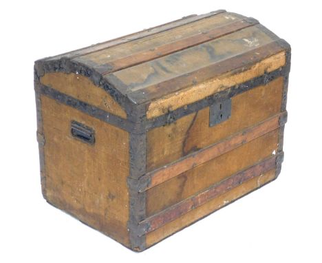 A Victorian canvas bound wooden trunk, with wooden and iron strapwork, hinged lid opening to reveal a tray top and vacant int