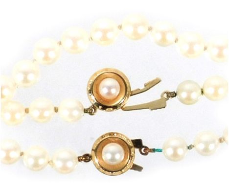 A string of uniform cultured pearls, on a circular 9ct gold and single pearl fishhook clasp, 46cm long., together with a matc