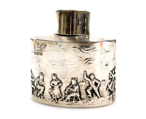 An Edward VII silver tea caddy, of oval, lidded form, repousse decorated with a country pastoral scene of figures dancing, Bi