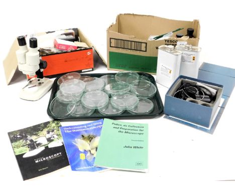 A compound microscope case, microscope, petri dishes, assorted tools, cased, syringes, liquids and microscopy booklets. (a qu