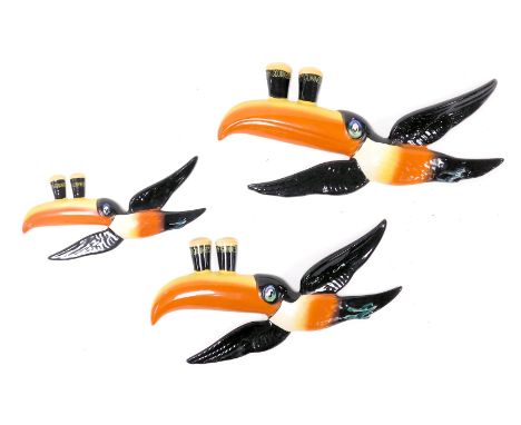 A set of three Carltonware graduated flying Guinness Toucan wall plaques, the pair of glasses painted with "My Goodness My Gu