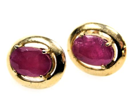 A pair of 9ct gold and ruby single stone earrings, in an oval, claw setting, 