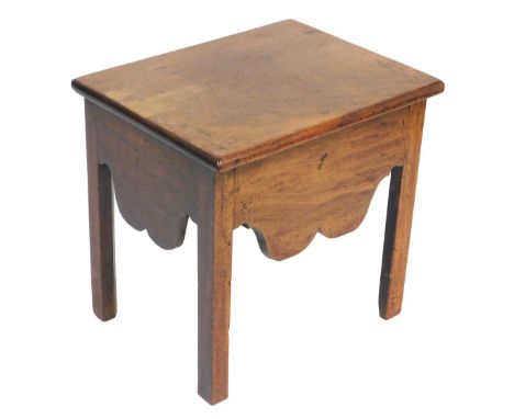 A George III mahogany stool, formerly a commode, with a hinged lid, and shaped apron, raised on square legs, 48cm wide.