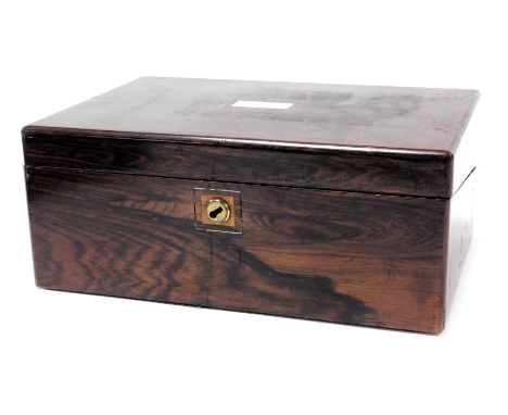 A Victorian rosewood writing slope, with a mother of pearl escutcheon, opening to reveal a fitted interior, 25.5cm wide, 24.5