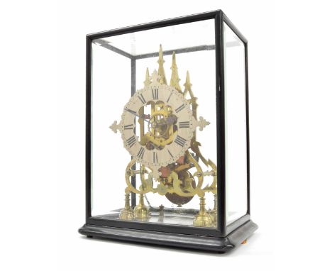 Electric re-wind brass electric skeleton clock, the 7.75" silvered chapter ring enclosing a skeletonised centre, upon curving