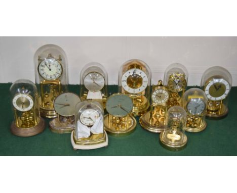 Twelve various torsion style and electric mantel clocks under glass domes, tallest 12" high (variable condition and three wit