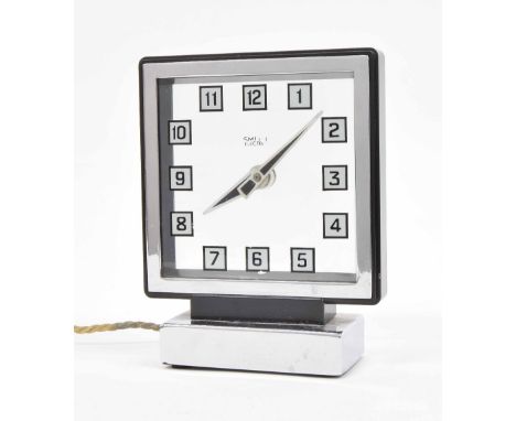 Smith electric mystery mantel clock, the 5" square Perspex dial within a chrome surround and upon a stepped rectangular stand
