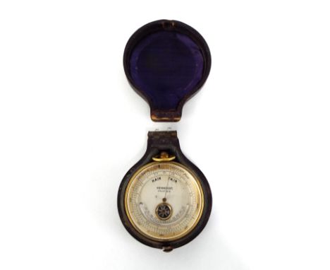 Brass cased pocket barometer with compass aperture, signed Hennessy, Swansea, 1.75" diameter, with the original Morocco leath