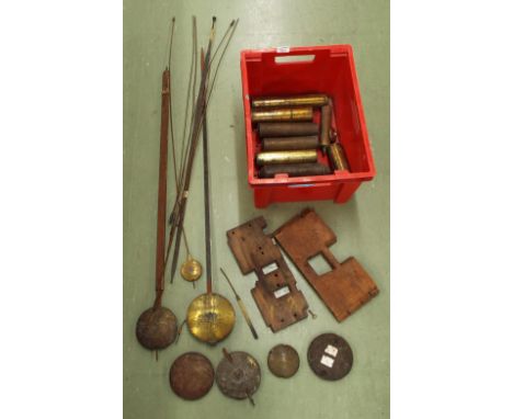 Nine various brass weights, quantity of pendulums and two longcase clock seat boards