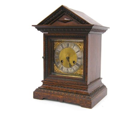 German oak ting-tang mantel clock striking on two gongs, within a stepped case carved with egg and dart friezes and surmounte