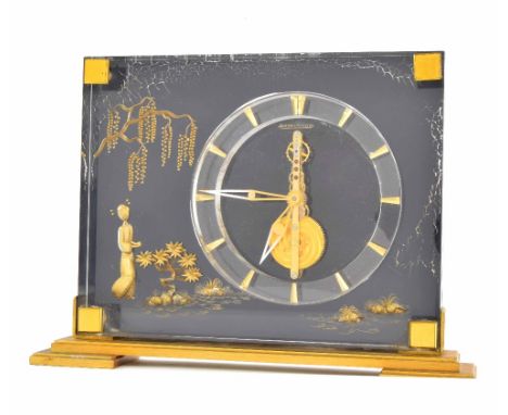 Jaeger LeCoultre skeletonised eight day mantel clock, with gilt chinoiserie style decoration on a dark ground, supported upon
