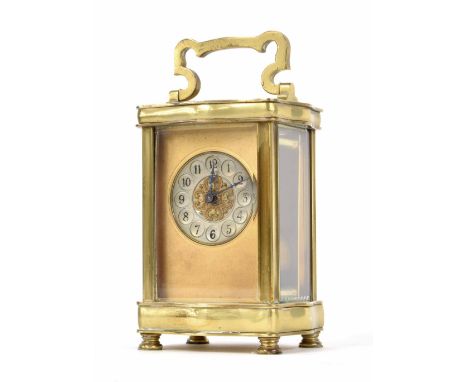 Carriage clock timepiece, the 1.75" silvered chapter ring within a gilt mask and serpentine shaped brass case, 6.5" high
