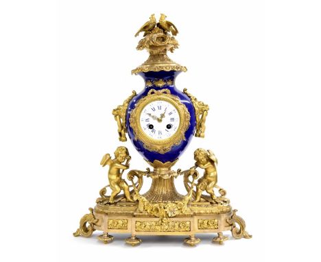 French gilt metal and blue porcelain two train decorative mantel clock striking on a bell, the 3.5" white dial inset into a v