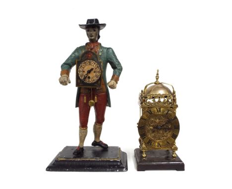 Novelty painted spelter clock pedlar modelled as a man standing with a clock fixed to his chest, upon a rectangular stepped s