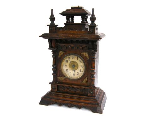 German oak musical alarm mantel clock timepiece, the 3.5" cream dial within an architectural case, 15" high (missing top fini
