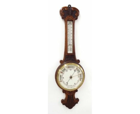 Oak aneroid barometer/thermometer within a foliate carved case