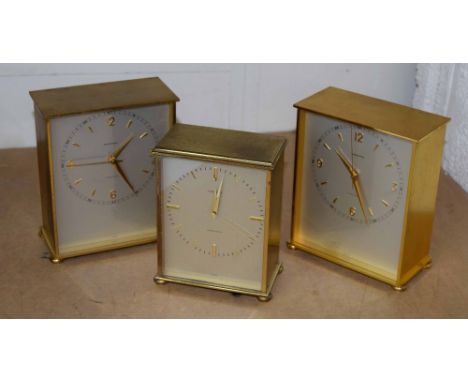 Three Garrard Precision electric mantel clocks, all with centre seconds, silvered dials and within brushed brass cases, talle