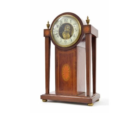 Eureka electric mahogany mantel clock within an inlaid Sheraton case, the 4.5" cream chapter ring enclosing a skeletonised ce