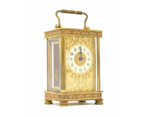 Brass carriage clock timepiece, the 1.75" cream chapter ring enclosing a gilt centre and within a pierced foliate mask and or