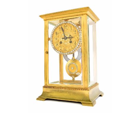 French brass four glass two train mantel clock striking on a gong, the 4" gilt concave dial within a paste set bezel over a m