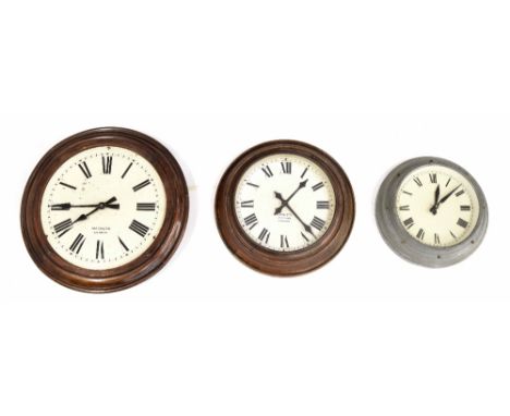 Magneta 12" wall dial slave clock, within a turned oak surround; also another Magneta electric wall dial slave clock within a