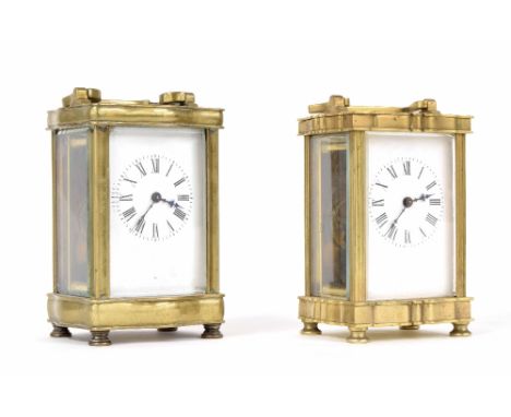 Two similar carriage clock timepieces, within serpentine brass cases, both approx 6" high and with keys (2)