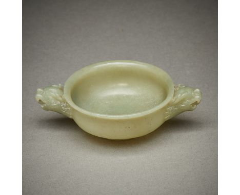 Modern Chinese carved jade bowl with foo dog handles. In a yellow-green coloration.Height: 1 1/4 in x width: 4 1/4 in x depth