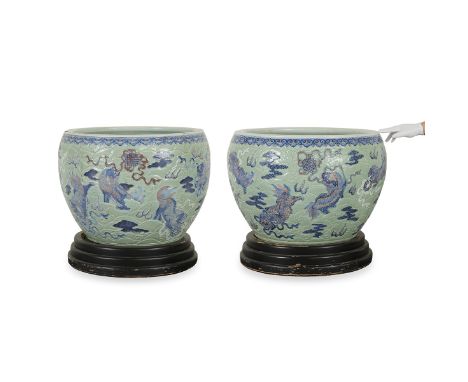 Pair of massive 18th-century Chinese celadon fish bowls with incised and relief decoration. The exterior of the bowl is decor