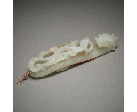 Chinese pale jade belt hook carving in the form of a dragon. With a sticker from Ming's, a Minneapolis Chinese antique shop t