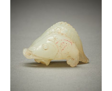 Chinese pale jade carving depicting two fish which seem to fight over a single object or plant. The form is a masterpiece of 