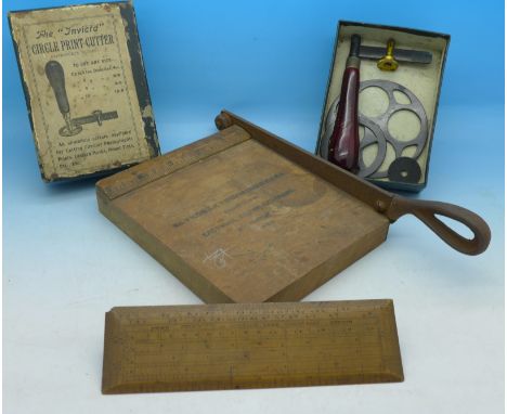 A circle print cutter, boxed, a wooden photograph guillotine marked No.1 Kodak trimming board, Eastman Kodak Company and a ru