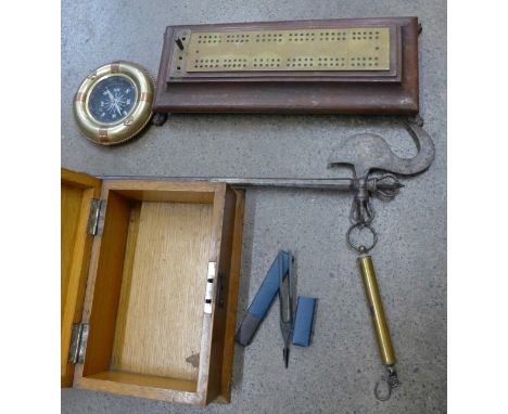 An oak wooden box, a cribbage board counter, circular brass compass, Boosey & Hawkes tuner, Salter scales, etc.