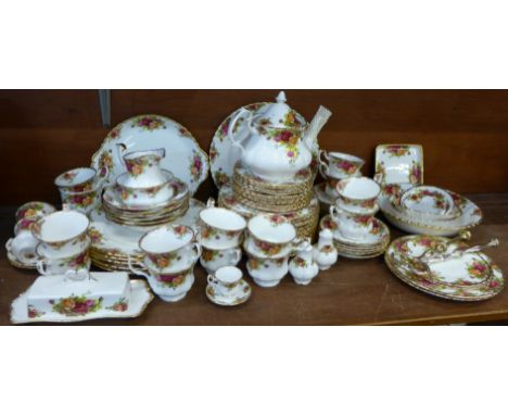 A collection of Royal Albert Old Country Roses tea and dinnerware, etc., including thirteen cups, twelve saucers, teapot, cre