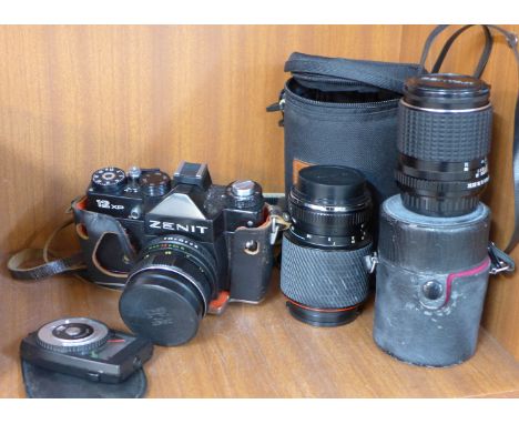 A Zenit 12XP 35mm film camera, two additional lenses and light meter