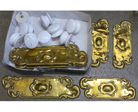 Six Art Nouveau brass door plates and nine ceramic cabinet knobs